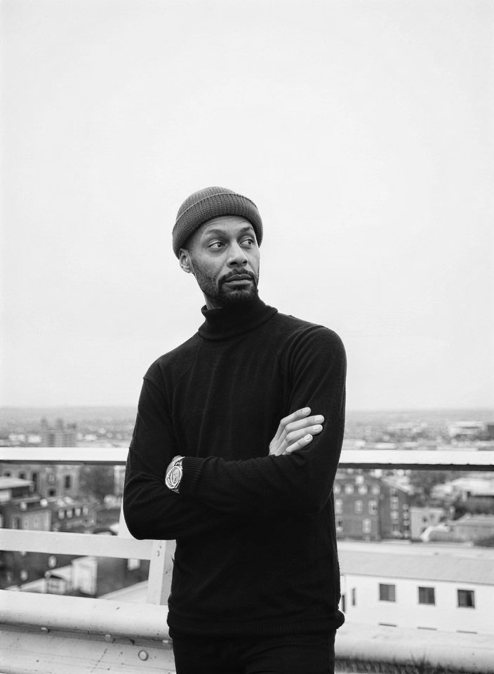 Man on a city rooftop in black and white